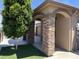Inviting desert landscaping with mature trees, stone and stucco details, and a welcoming entryway at 15625 N Jerry St, Surprise, AZ 85378