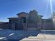 Charming single-story home featuring a private gated entrance, desert landscaping, and a welcoming covered entryway at 15625 N Jerry St, Surprise, AZ 85378