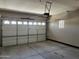 Spacious garage featuring an automatic garage door opener and a large window at 15625 N Jerry St, Surprise, AZ 85378