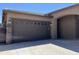 A spacious two-car garage, conveniently attached with an oversized driveway and traditional doors at 15625 N Jerry St, Surprise, AZ 85378