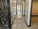 Hallway featuring sleek tile floors and arched doorways, flowing seamlessly into adjacent spaces at 15625 N Jerry St, Surprise, AZ 85378