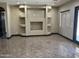This living room has custom built-in shelves and tile floors at 15625 N Jerry St, Surprise, AZ 85378