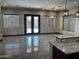 This living room has tile floors, modern lighting, and views of the outdoor space at 15625 N Jerry St, Surprise, AZ 85378