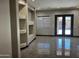 This living room has tile floors and double doors to the backyard at 15625 N Jerry St, Surprise, AZ 85378