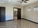 An expansive primary bedroom features a ceiling fan, three windows, and ensuite bathroom with a glass shower stall at 15625 N Jerry St, Surprise, AZ 85378