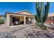 Covered back patio area with plenty of space for seating and a desert landscape at 17317 N Ponca Way, Surprise, AZ 85374