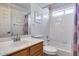 Bathroom featuring a tiled shower/tub combo, commode, and a wooden vanity with sink at 17317 N Ponca Way, Surprise, AZ 85374