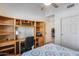 Bedroom featuring built in desk, natural lighting, and an open view of the hallway at 17317 N Ponca Way, Surprise, AZ 85374