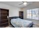 Bedroom featuring a bed, ceiling fan, and a window for natural lighting at 17317 N Ponca Way, Surprise, AZ 85374