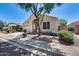 Charming single-story home featuring desert landscaping, mature shade tree and inviting front entry at 17317 N Ponca Way, Surprise, AZ 85374