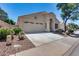 Lovely single-story home boasts a two-car garage, desert landscaping, and an inviting entrance at 17317 N Ponca Way, Surprise, AZ 85374