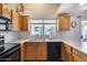 Well-equipped kitchen with wood cabinetry, neutral countertops and modern appliances at 17317 N Ponca Way, Surprise, AZ 85374