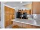 Lovely kitchen featuring ample cabinetry, modern appliances and a convenient breakfast bar at 17317 N Ponca Way, Surprise, AZ 85374
