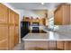 Spacious kitchen featuring ample cabinetry, modern appliances and a convenient breakfast bar at 17317 N Ponca Way, Surprise, AZ 85374