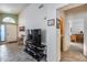 Living room with TV, modern tile, natural lighting, and view of the front door at 17317 N Ponca Way, Surprise, AZ 85374