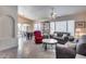 Spacious living room with views of the backyard, dining room, and plenty of comfortable seating at 17317 N Ponca Way, Surprise, AZ 85374