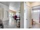Open-concept living room with tile floors, dining area, and view of a full bathroom at 17317 N Ponca Way, Surprise, AZ 85374