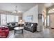 Comfortable living room featuring tile floors, bright windows, and ample seating space at 17317 N Ponca Way, Surprise, AZ 85374