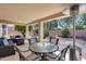 Inviting outdoor patio area with comfortable seating, a table, and a view of the landscaped backyard at 17317 N Ponca Way, Surprise, AZ 85374