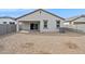 Home's backyard features a covered patio, sliding glass doors, gravel landscaping, and central air conditioning unit at 17830 W Vogel Ave, Waddell, AZ 85355