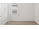 Bedroom with carpeting, natural light, and white door at 17830 W Vogel Ave, Waddell, AZ 85355