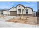 Charming home showcasing desert landscaping, a two-car garage, and neutral stucco exterior at 17830 W Vogel Ave, Waddell, AZ 85355