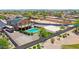 Aerial view of backyard showcasing a refreshing pool, sport court, RV parking, and solar panels at 1932 S 220Th Dr, Buckeye, AZ 85326