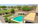 Aerial view of backyard showing desert landscaping, refreshing pool and raised deck at 1932 S 220Th Dr, Buckeye, AZ 85326