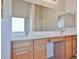 Bright bathroom with double sinks, neutral counter tops and wood cabinets at 1932 S 220Th Dr, Buckeye, AZ 85326