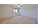 Neutral bedroom featuring carpet, ceiling fan, and a window with roller shade at 1932 S 220Th Dr, Buckeye, AZ 85326