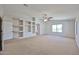 Expansive bedroom featuring a ceiling fan, arched doorway, and a custom shelving unit at 1932 S 220Th Dr, Buckeye, AZ 85326