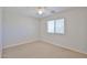 Bedroom with a large window and neutral carpet at 1932 S 220Th Dr, Buckeye, AZ 85326