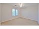 Bright bedroom with a large window and neutral carpet at 1932 S 220Th Dr, Buckeye, AZ 85326