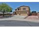 Two-story home featuring a three-car garage, landscaped front yard, and a large driveway with RV gate at 1932 S 220Th Dr, Buckeye, AZ 85326
