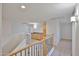 Upstairs hallway featuring wooden banister and built-in cabinets at 1932 S 220Th Dr, Buckeye, AZ 85326