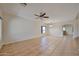Bright living room featuring ceiling fan, tile floors, and natural light at 1932 S 220Th Dr, Buckeye, AZ 85326