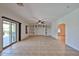 Open-concept living room featuring tile flooring, a ceiling fan, and sliding glass door at 1932 S 220Th Dr, Buckeye, AZ 85326