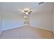 Spacious living room with ceiling fan and neutral carpet at 1932 S 220Th Dr, Buckeye, AZ 85326
