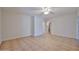Spacious living room featuring neutral paint, tile flooring, and a ceiling fan at 1932 S 220Th Dr, Buckeye, AZ 85326