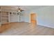 Large living room features tile flooring, ceiling fan, and built-in shelving at 1932 S 220Th Dr, Buckeye, AZ 85326