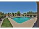Inviting backyard pool featuring a well-kept deck and artificial turf at 1932 S 220Th Dr, Buckeye, AZ 85326