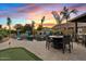 Gorgeous backyard with a pool, putting green, and an outdoor kitchen, perfect for entertaining at 19748 E Walnut Rd, Queen Creek, AZ 85142