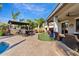 Backyard features an outdoor bar, a pergola, a putting green, and an in-ground pool at 19748 E Walnut Rd, Queen Creek, AZ 85142