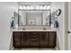 Double sink bathroom with large mirror, granite counters, and modern fixtures at 19748 E Walnut Rd, Queen Creek, AZ 85142