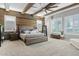 Stunning main bedroom features a wood accent wall, wooden beams, and plush carpet flooring at 19748 E Walnut Rd, Queen Creek, AZ 85142