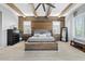 Comfortable bedroom boasts a decorative wood accent wall, exposed beams and plenty of natural light at 19748 E Walnut Rd, Queen Creek, AZ 85142