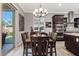 A dining room showcases a chandelier, a table with six chairs, and tile flooring at 19748 E Walnut Rd, Queen Creek, AZ 85142