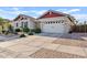 Well-maintained home features a white garage door, neutral color scheme, and a beautifully landscaped front yard at 19748 E Walnut Rd, Queen Creek, AZ 85142