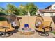 A cozy fire pit is surrounded by chairs in the backyard at 19748 E Walnut Rd, Queen Creek, AZ 85142