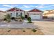 Beautiful home with desert landscaping, well-manicured shrubs and a large two-car garage at 19748 E Walnut Rd, Queen Creek, AZ 85142